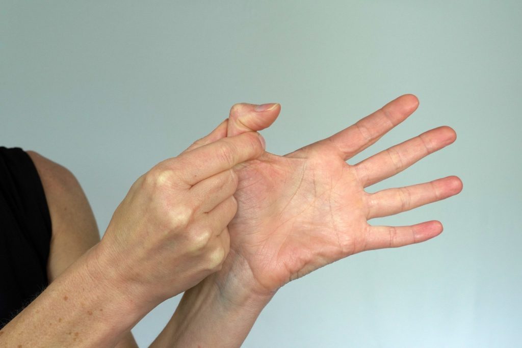Picture shows using opposite hand to block the thumb, allowing only the tip of the thumb to bend.
