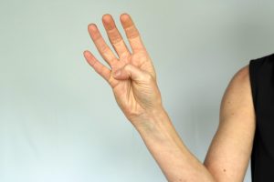Active thumb flexion across palm exercise