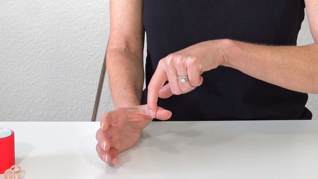 Image shows hand positioned in a C position with hand resting on table, small finger side down.